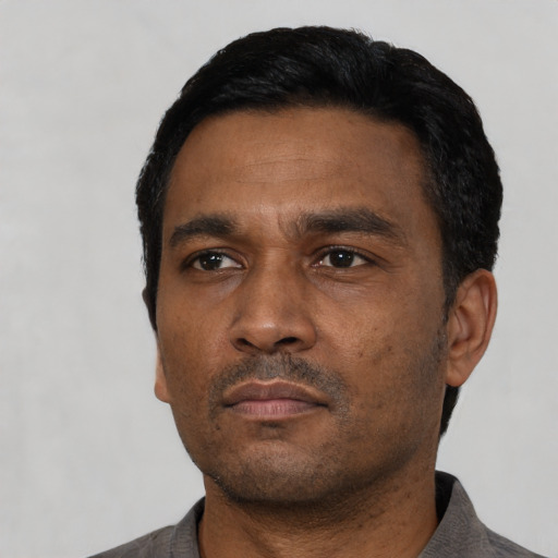 Neutral black adult male with short  black hair and brown eyes