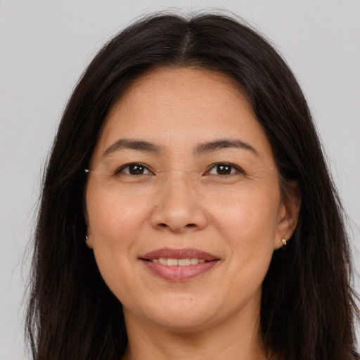 Joyful white adult female with long  brown hair and brown eyes