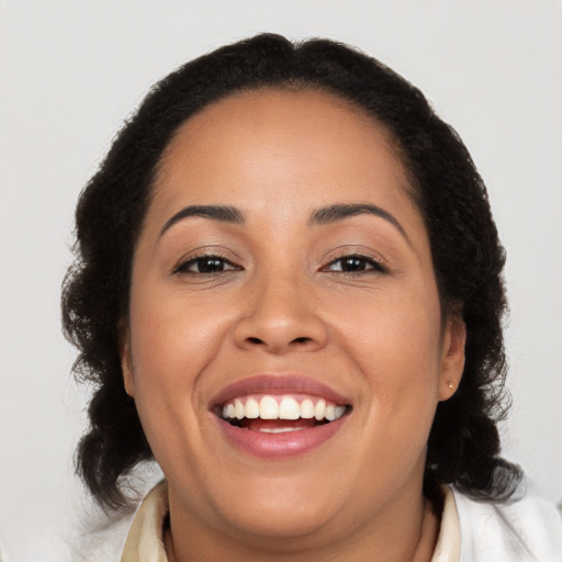 Joyful latino young-adult female with medium  brown hair and brown eyes