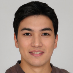 Joyful asian young-adult male with short  black hair and brown eyes