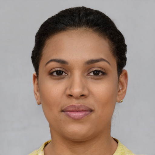 Joyful latino young-adult female with short  brown hair and brown eyes