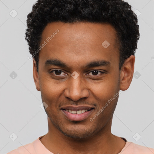 Joyful black young-adult male with short  brown hair and brown eyes