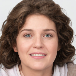 Joyful white young-adult female with medium  brown hair and green eyes