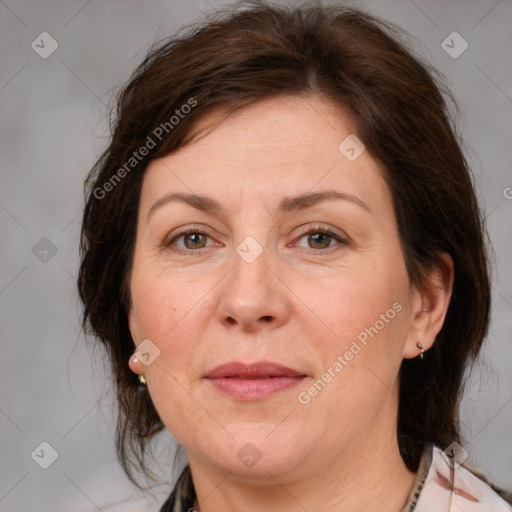 Joyful white adult female with medium  brown hair and brown eyes