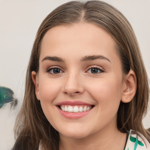 Joyful white young-adult female with long  brown hair and green eyes