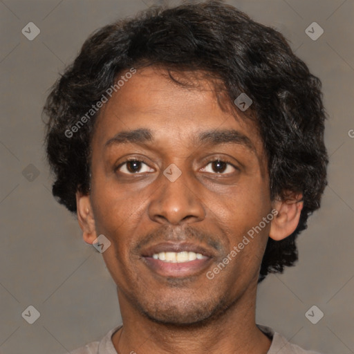 Joyful black young-adult male with short  brown hair and brown eyes