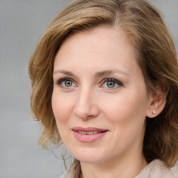 Joyful white young-adult female with medium  brown hair and blue eyes