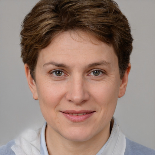 Joyful white adult female with short  brown hair and grey eyes