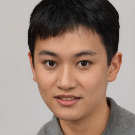 Joyful asian young-adult male with short  brown hair and brown eyes