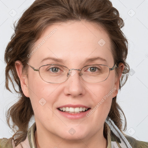 Joyful white adult female with medium  brown hair and blue eyes