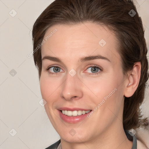 Joyful white young-adult female with medium  brown hair and grey eyes