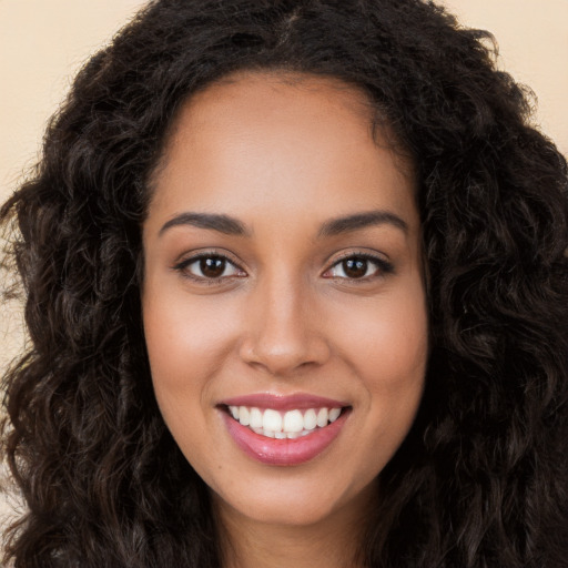 Joyful white young-adult female with long  black hair and brown eyes