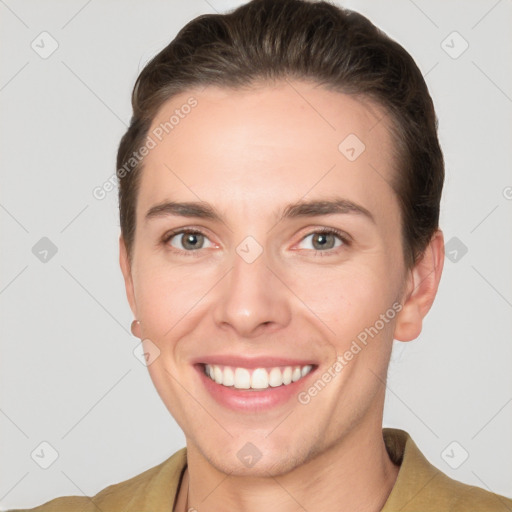 Joyful white young-adult female with short  brown hair and grey eyes