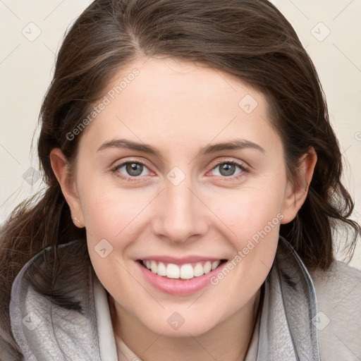 Joyful white young-adult female with medium  brown hair and blue eyes