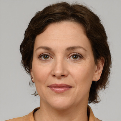 Joyful white adult female with medium  brown hair and grey eyes