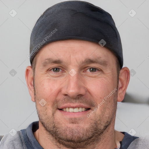 Joyful white adult male with short  brown hair and grey eyes