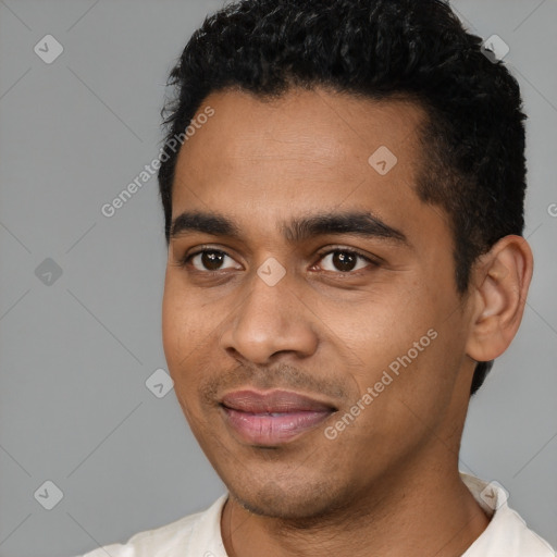Joyful latino young-adult male with short  black hair and brown eyes