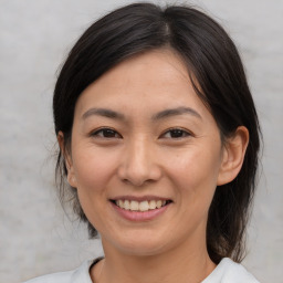 Joyful asian young-adult female with medium  brown hair and brown eyes