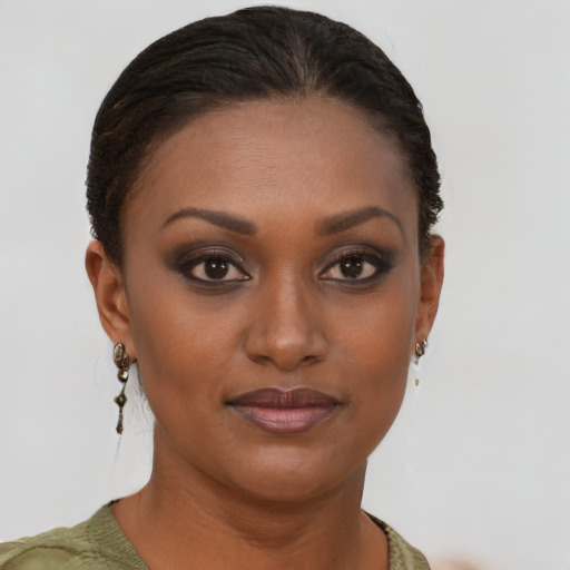 Joyful black young-adult female with short  brown hair and brown eyes