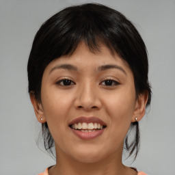 Joyful asian young-adult female with medium  brown hair and brown eyes