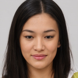 Joyful asian young-adult female with long  brown hair and brown eyes