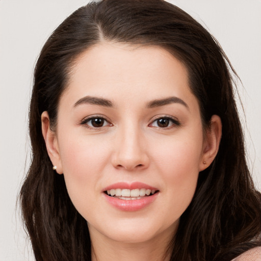 Joyful white young-adult female with long  brown hair and brown eyes