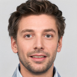 Joyful white young-adult male with short  brown hair and grey eyes