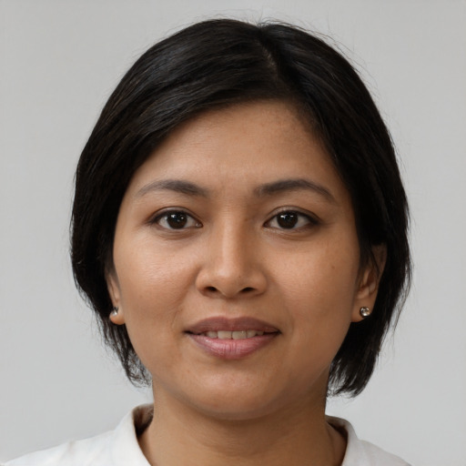 Joyful asian young-adult female with medium  black hair and brown eyes