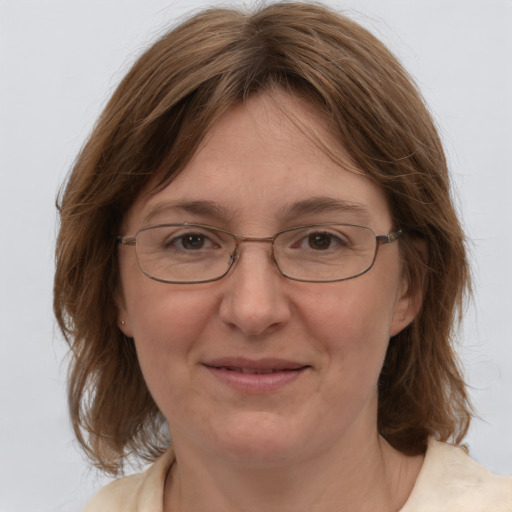 Joyful white adult female with medium  brown hair and blue eyes