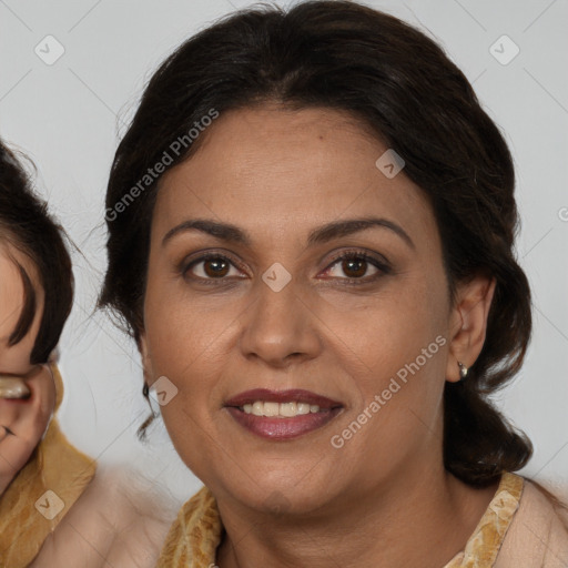 Joyful latino adult female with medium  brown hair and brown eyes