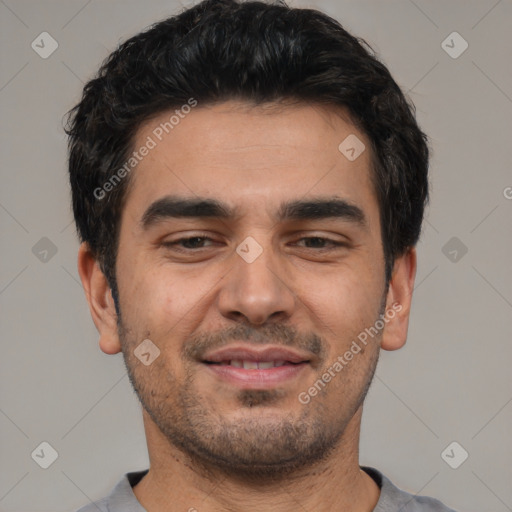 Joyful white young-adult male with short  black hair and brown eyes