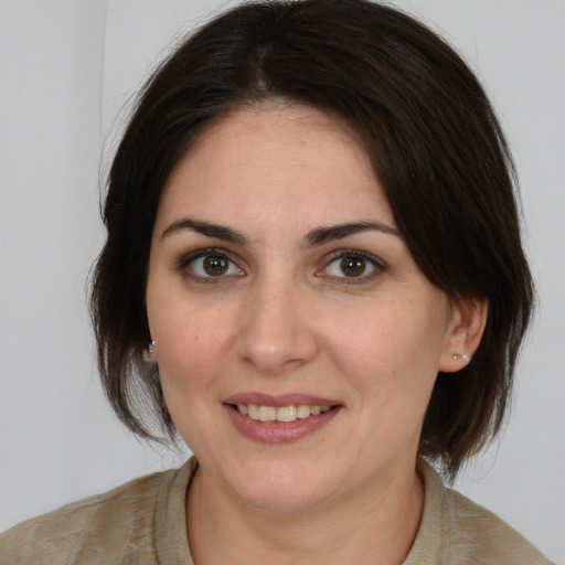 Joyful white young-adult female with medium  brown hair and brown eyes