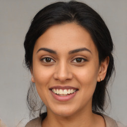 Joyful latino young-adult female with long  brown hair and brown eyes