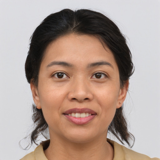 Joyful asian young-adult female with medium  brown hair and brown eyes