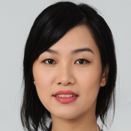 Joyful asian young-adult female with medium  black hair and brown eyes