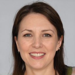 Joyful white adult female with long  brown hair and brown eyes