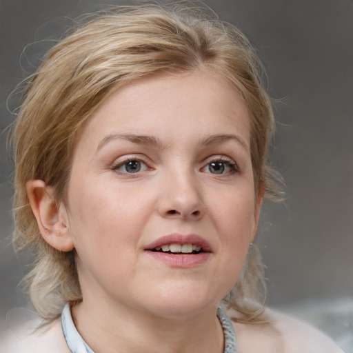 Joyful white young-adult female with medium  brown hair and blue eyes