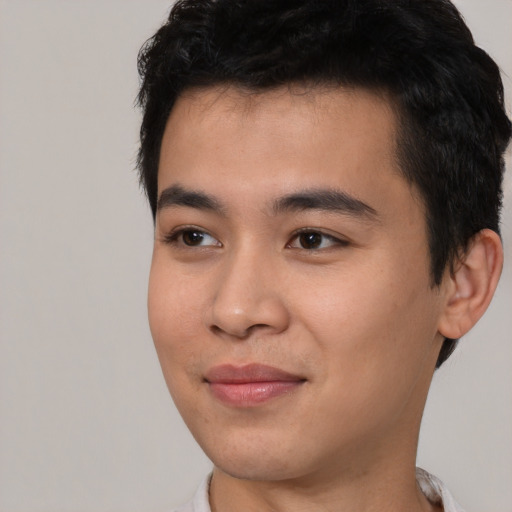 Joyful asian young-adult male with short  black hair and brown eyes