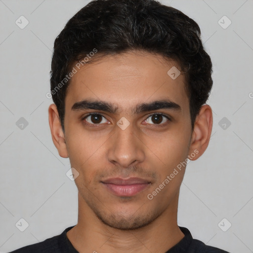 Joyful latino young-adult male with short  brown hair and brown eyes