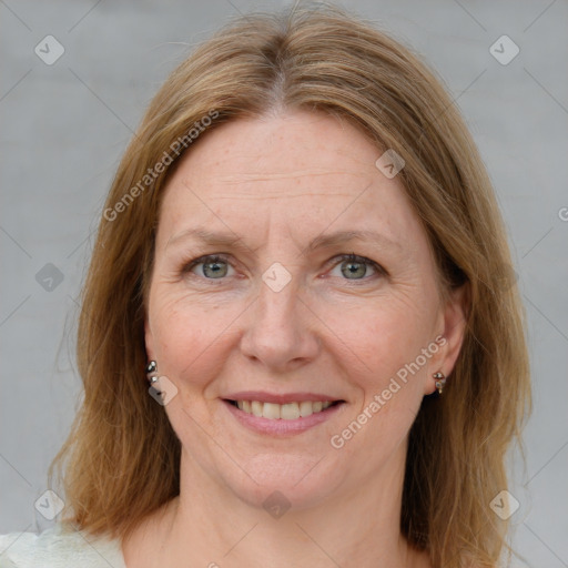 Joyful white adult female with medium  brown hair and blue eyes