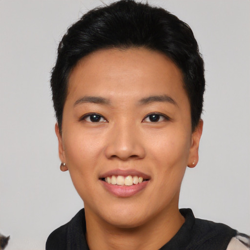 Joyful asian young-adult female with short  black hair and brown eyes