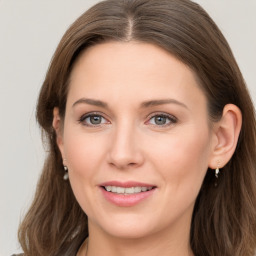 Joyful white young-adult female with long  brown hair and grey eyes