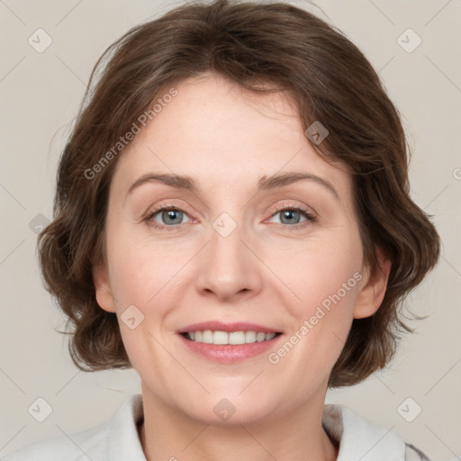 Joyful white adult female with medium  brown hair and green eyes