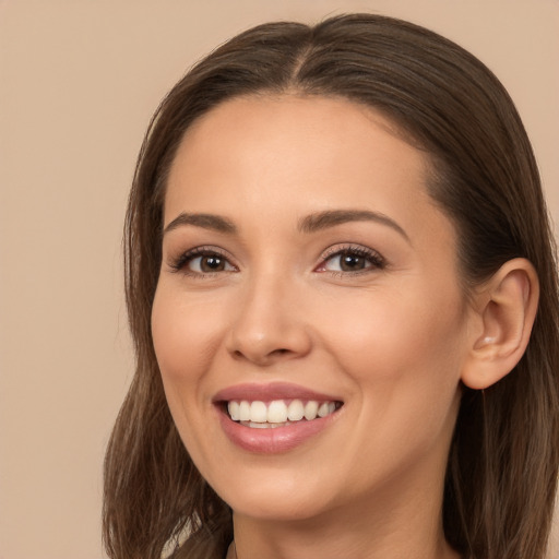 Joyful white young-adult female with long  brown hair and brown eyes