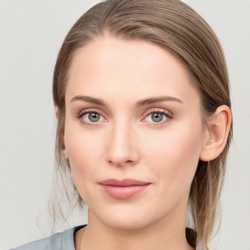 Joyful white young-adult female with medium  brown hair and blue eyes