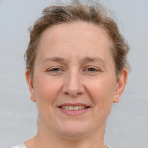 Joyful white adult female with short  brown hair and grey eyes