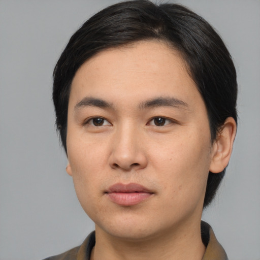 Joyful asian young-adult male with medium  black hair and brown eyes