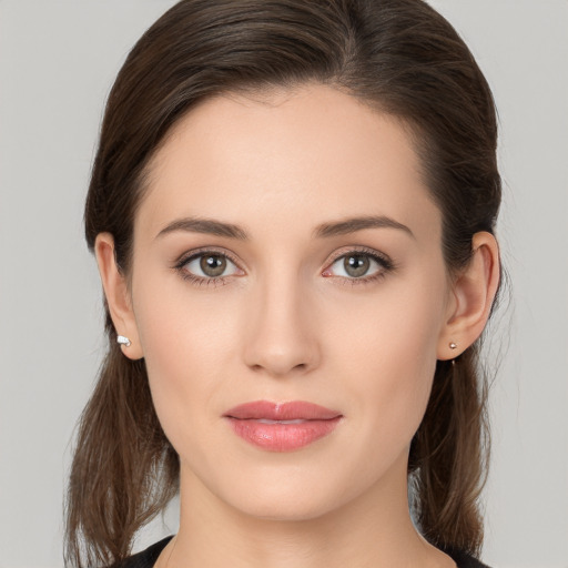 Joyful white young-adult female with long  brown hair and brown eyes