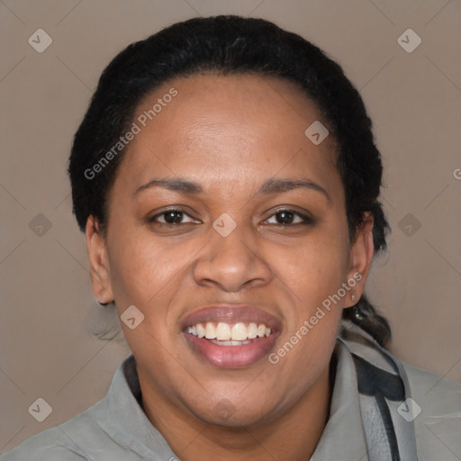 Joyful black adult female with short  black hair and brown eyes