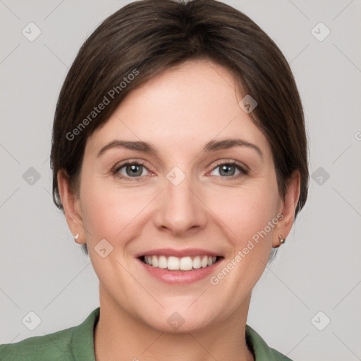 Joyful white young-adult female with short  brown hair and grey eyes